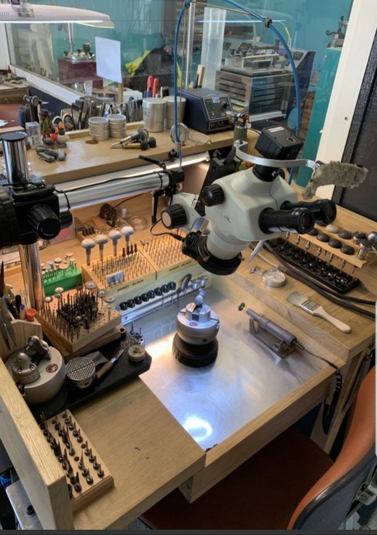 a table with many tools on it in a room filled with machines and other items