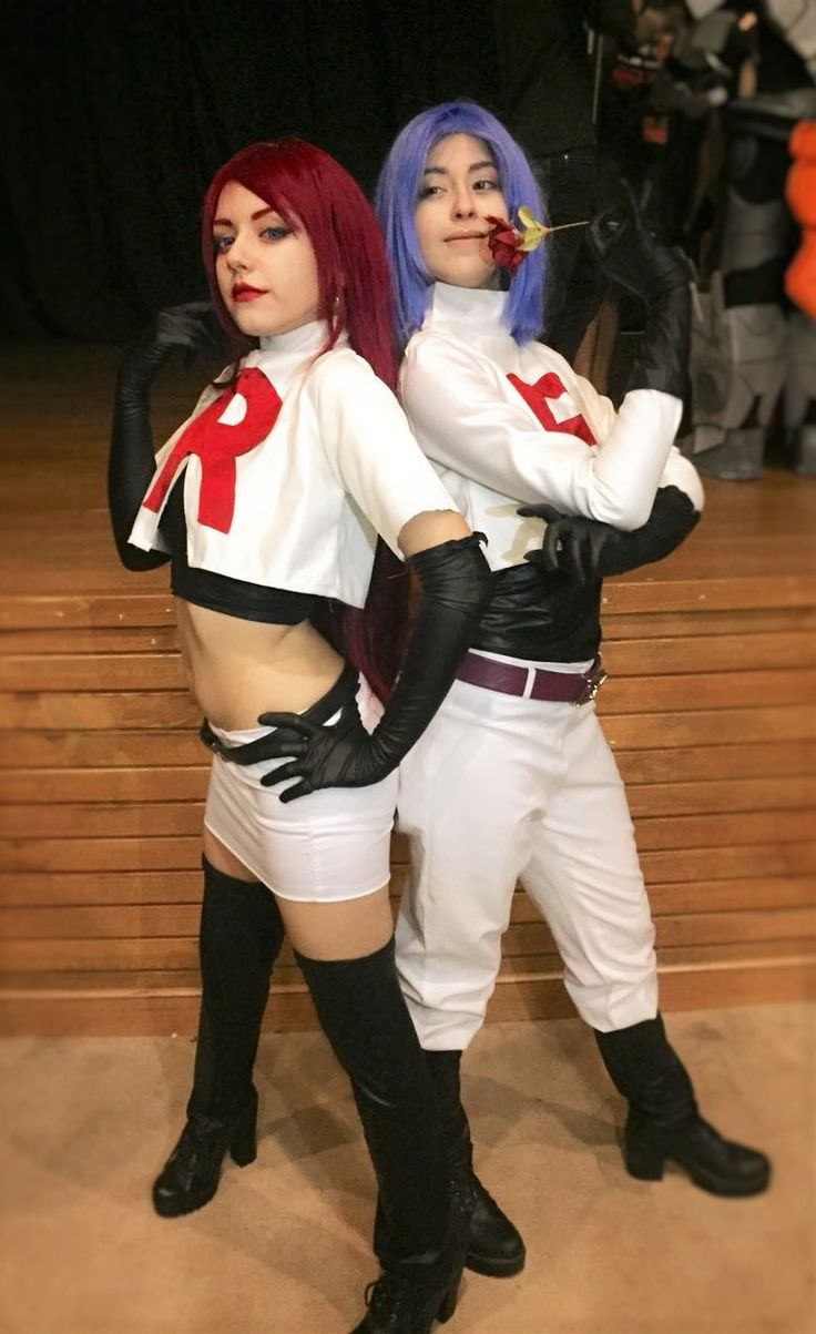 two women dressed in costumes standing next to each other