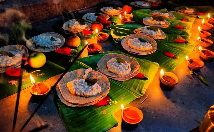 many plates with food on them and lit candles