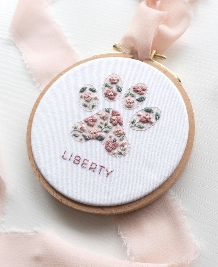 a cross stitch pattern with flowers and the words liberty on it