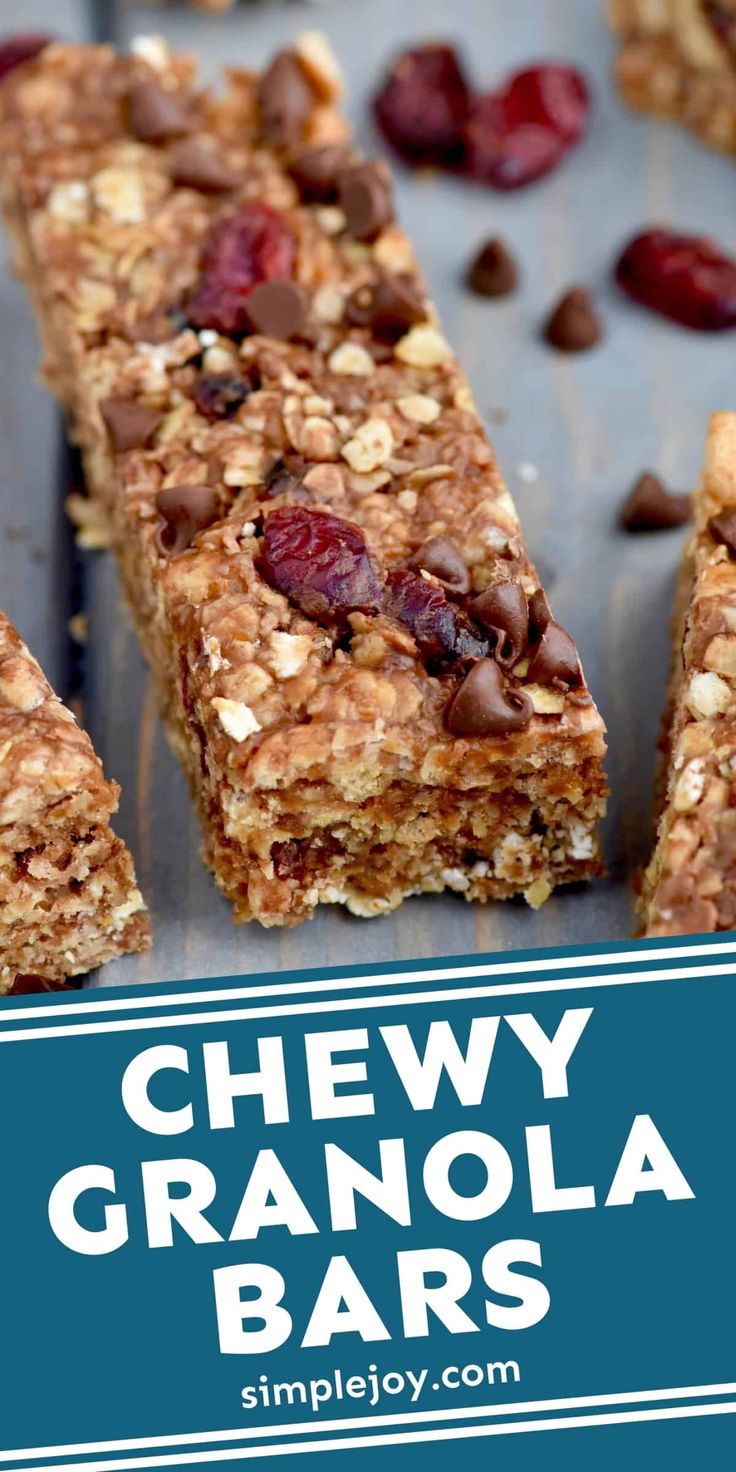 chewy granola bars with chocolate chips and dried cherries on top, in front of a blue background