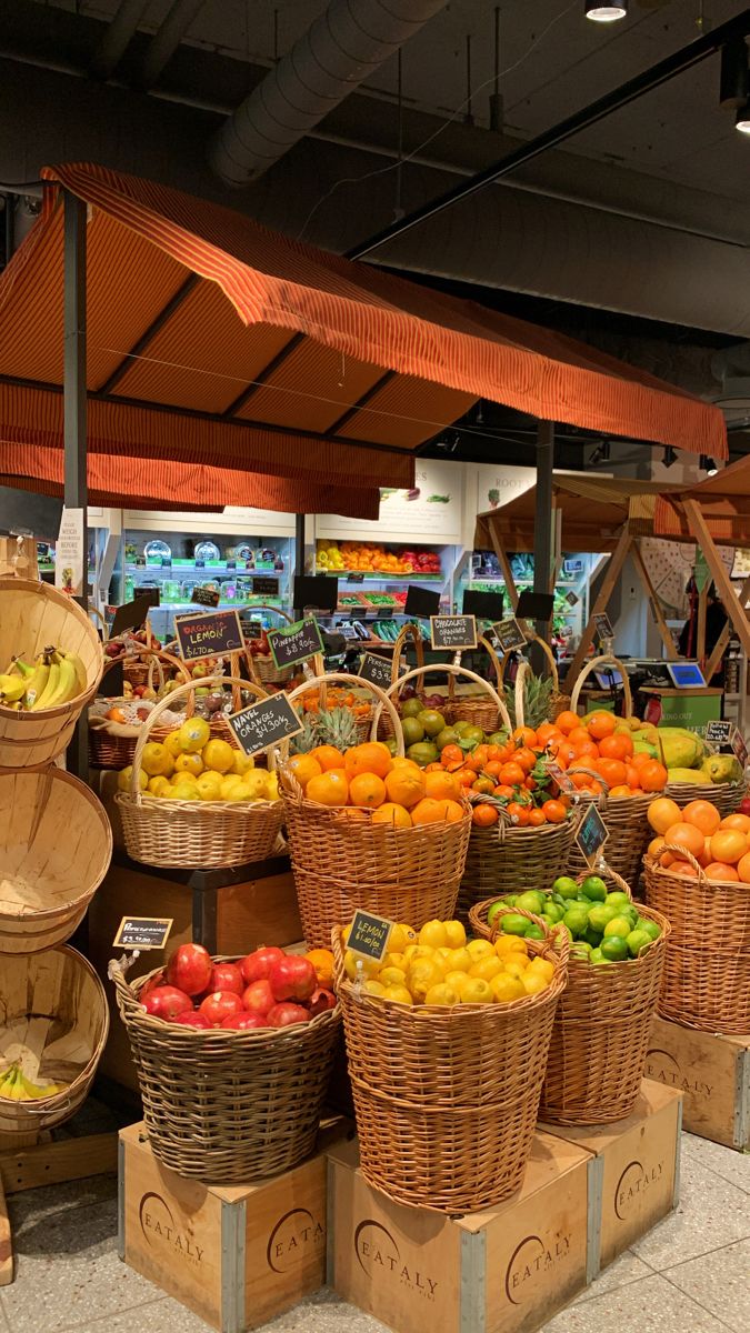 baskets of fruit are stacked on top of each other in the produce section of a grocery store