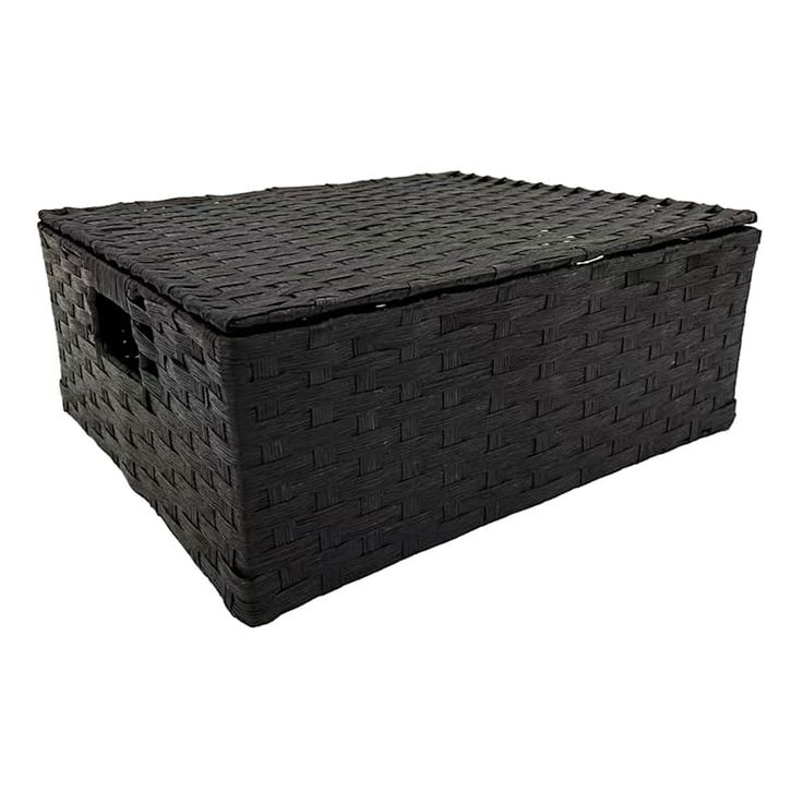 a large black basket sitting on top of a white floor