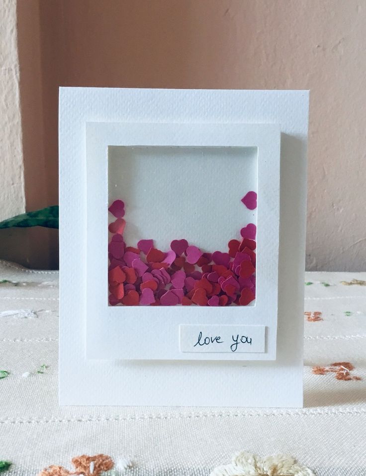 a white frame with pink flowers in it and the words love you written on it