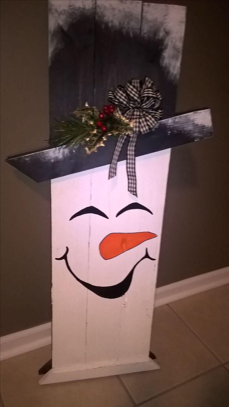 a white box with a snowman face painted on it's front and side