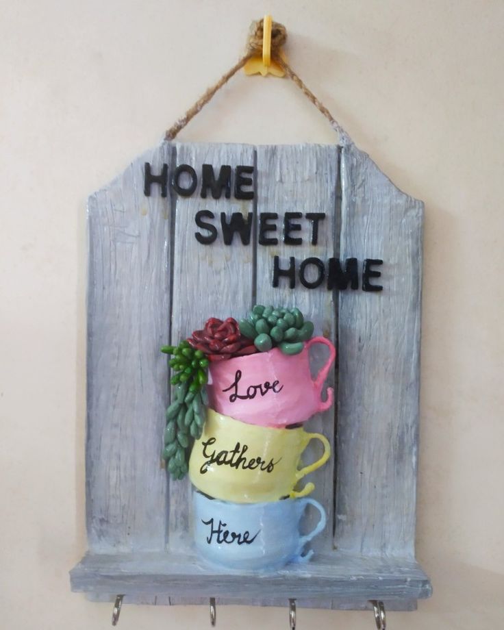 a wooden sign that says home sweet home and two mugs with grapes on them