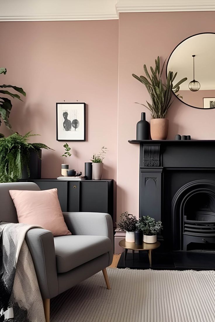 Neutral living room with blush pink walls, black fireplace, black sideboard, plants, blush pink accessories, and gray armchair Pink Living Room Walls, Pink Living Room Ideas, Blush Living Room, Blush Pink Living Room, Cozy Neutral Living Room, Blush Pink Bedroom, Pink Living Room Decor, Living Room Wall Color, Room Wall Colors