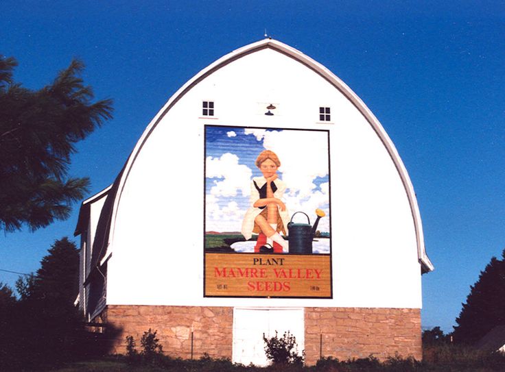 a large white building with a sign on it's side that says plant maine valley seeds