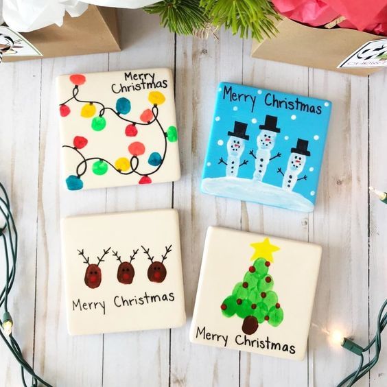 three decorated christmas cookies sitting on top of a table