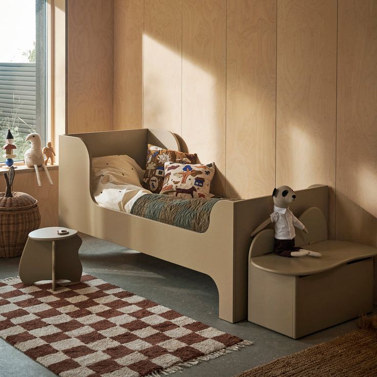 a child's bedroom with wooden walls and furniture