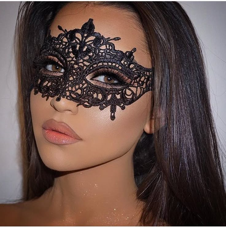 a woman wearing a black lace mask