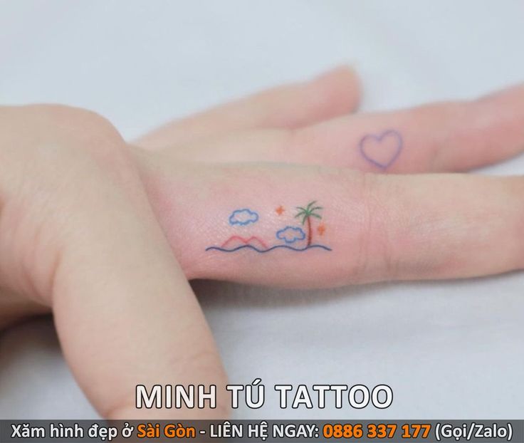 a small palm tree tattoo on the left hand is shown in blue ink, and pink ink