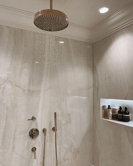 the shower head is mounted on the wall above the bathtub