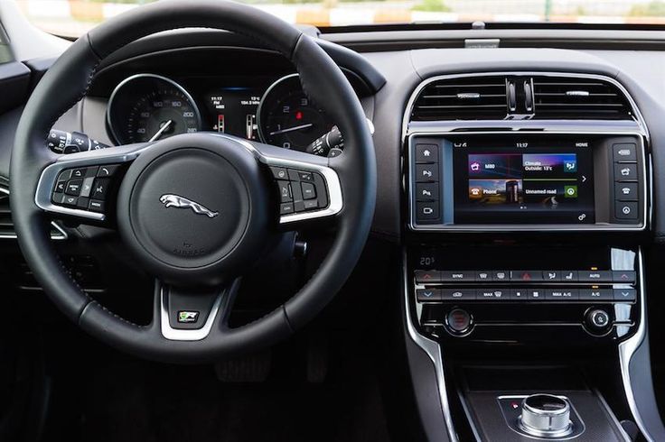 the interior of a car with steering wheel, dashboard and infotains on display