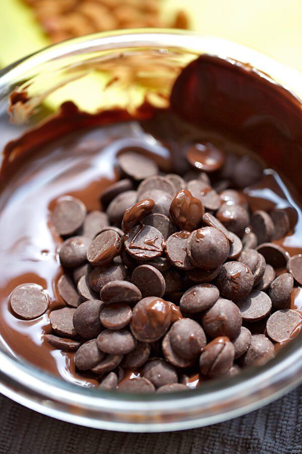 a bowl filled with chocolate chips on top of a table