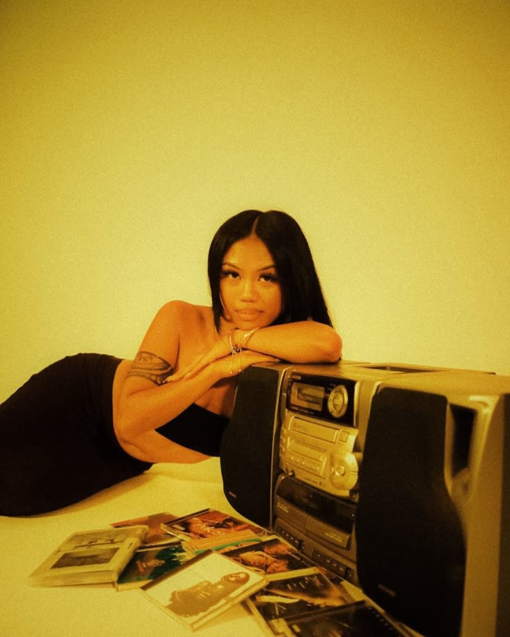 a woman laying on the floor next to a toaster oven with pictures around it