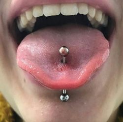 a person with a nose piercing attached to their tongue