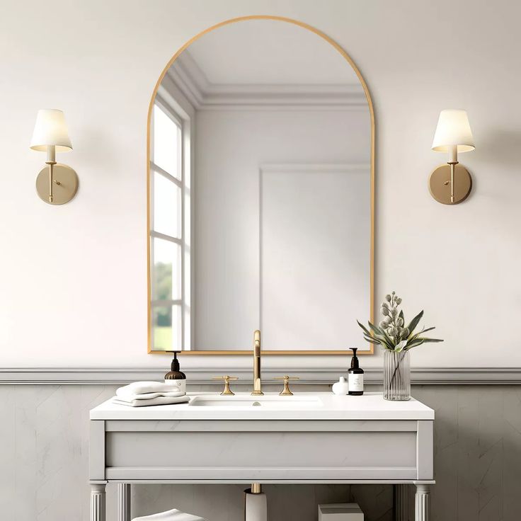 a white sink sitting under a mirror next to a wall mounted faucet in a bathroom