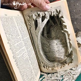 an open book with the pages cut out to look like a hole in the ground