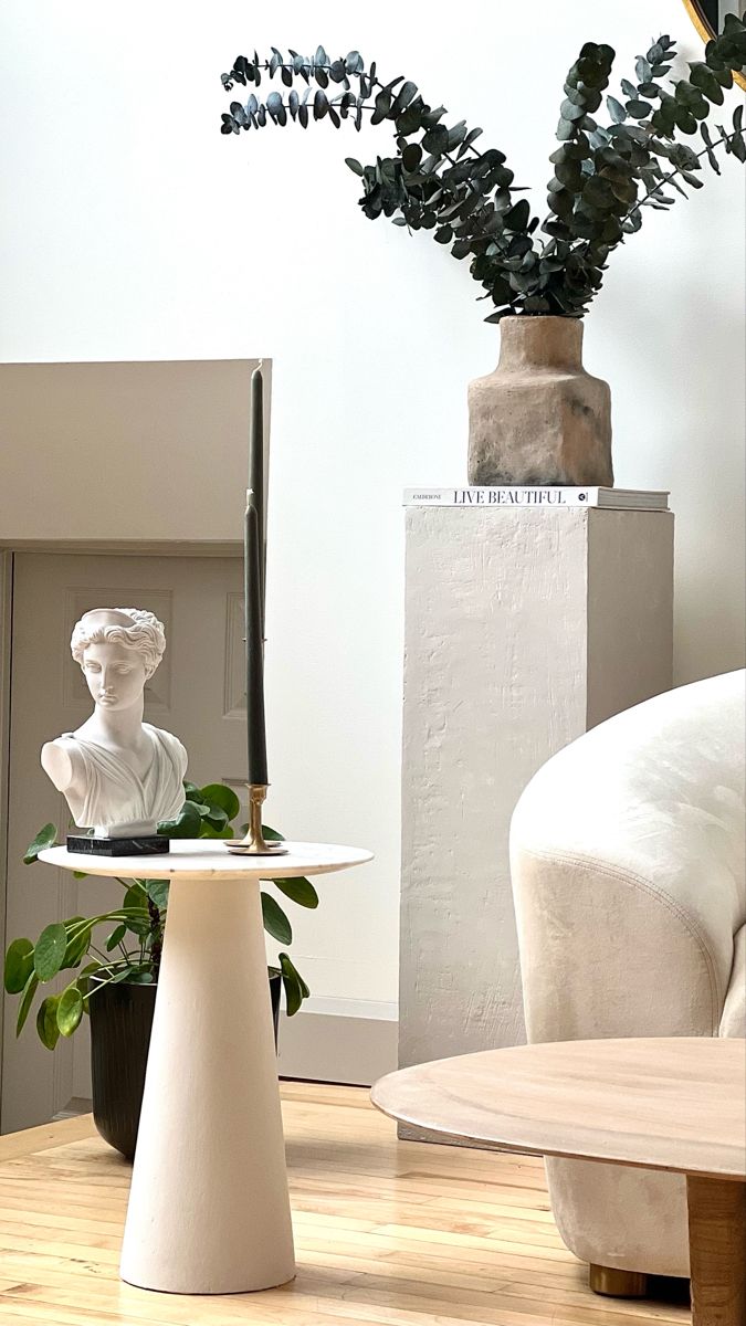 Pedestal table with marble top, pedestal cube with vase of eucalyptus Pedestal In Living Room, Marble Side Table Diy, Pedestal Living Room Decor, How To Make A Pedestal, Round Marble Side Table, Diy Plaster Side Table, Diy Cement Side Table, Round Pedestal Side Table, Pedestal Side Table Bedroom