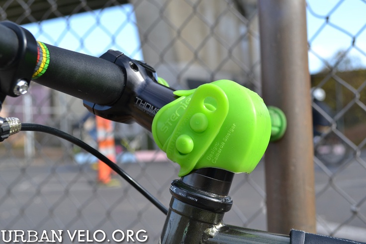 a close up view of the handlebars on a bike with a chain link fence in the background