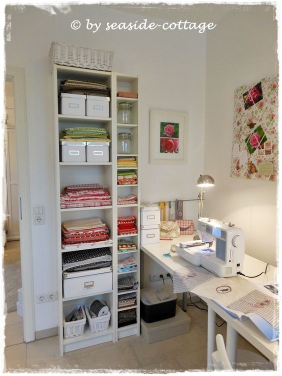 a sewing machine sitting on top of a table next to a shelf filled with fabric