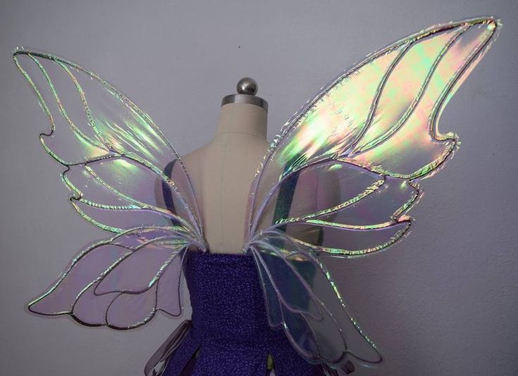 a purple and silver fairy costume with wings on top of a mannequin's head