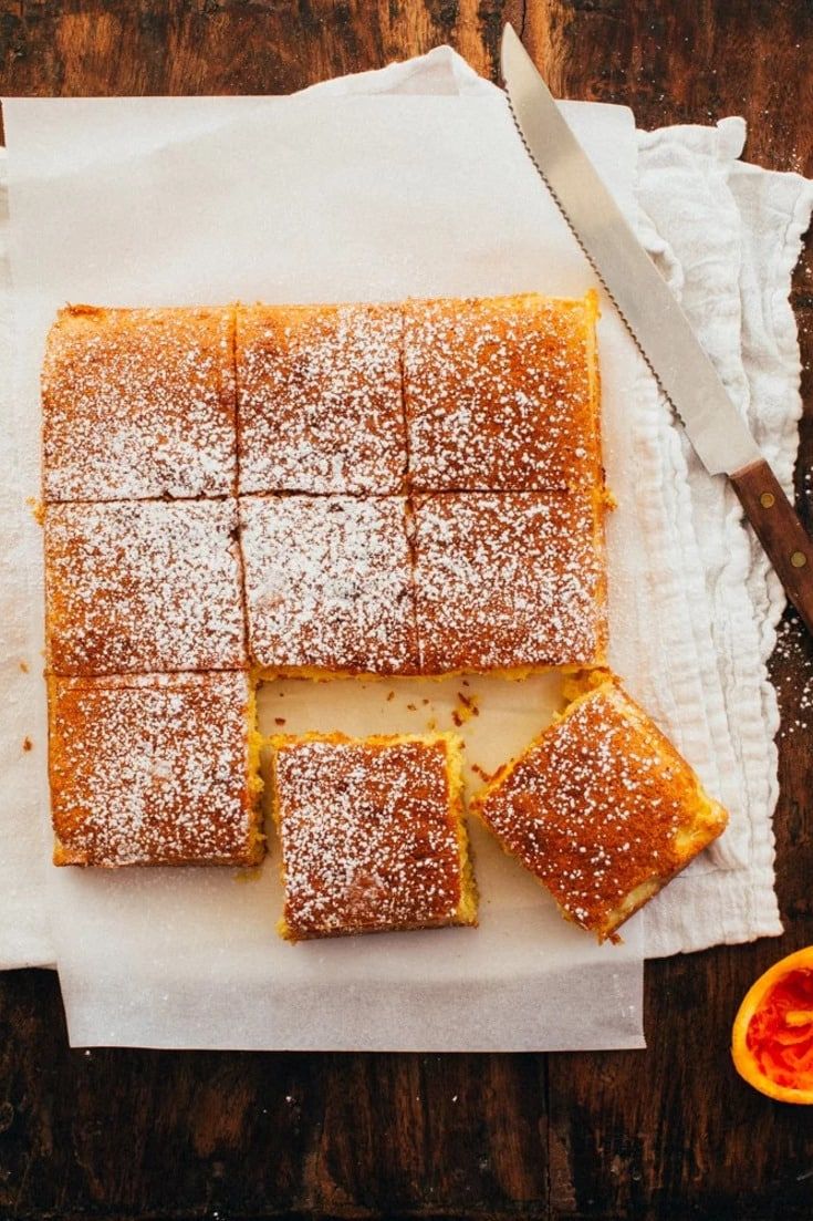 sliced orange bars sitting on top of a cutting board next to slices of grapefruit