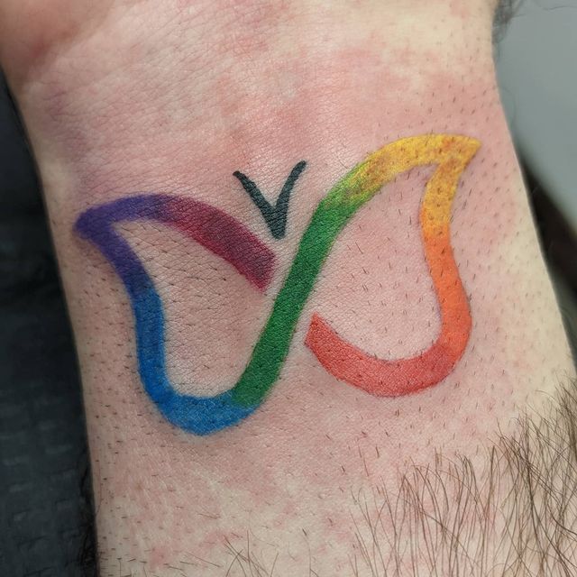 a man with a tattoo on his wrist that has the olympic symbol painted on it