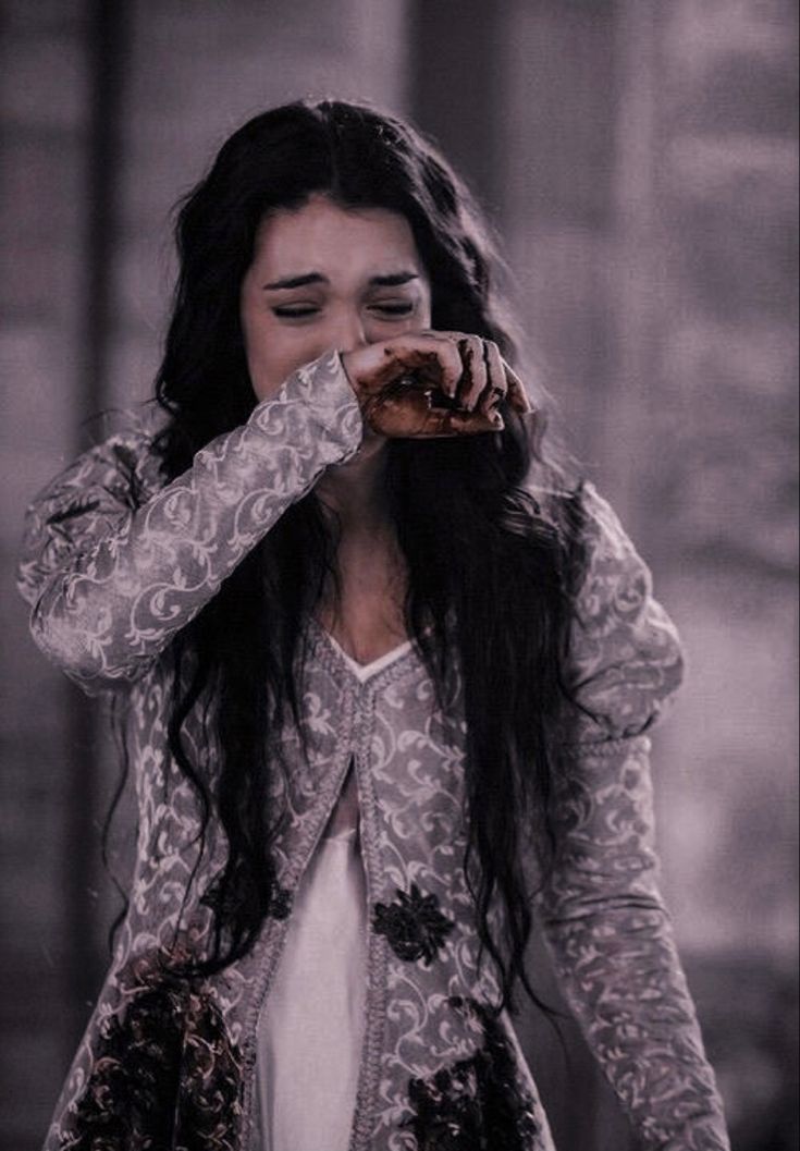 a woman with long black hair eating food