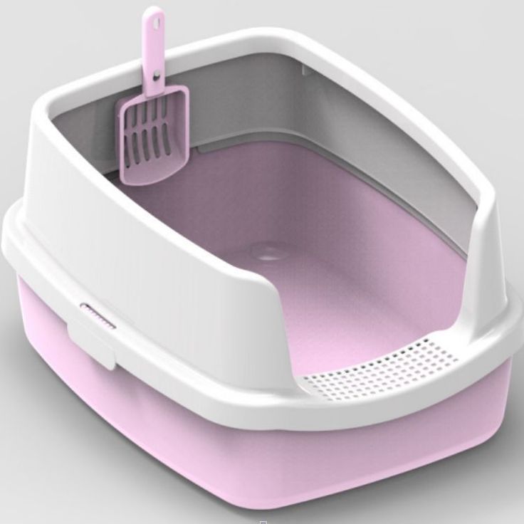 a pink and white litter box with a scoop inside