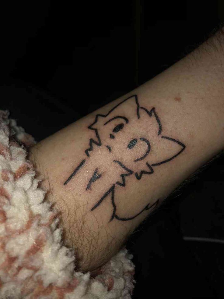 a person's arm with a cat tattoo on the left side of their arm