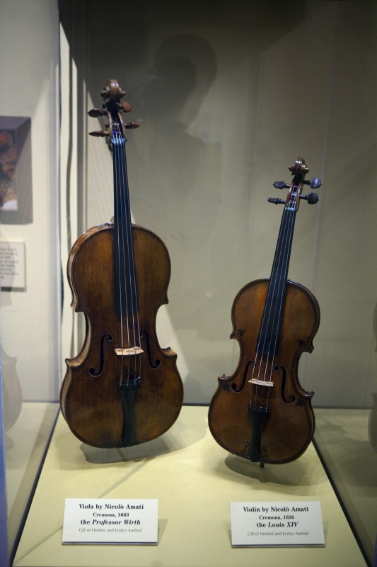 two violin's on display in a glass case