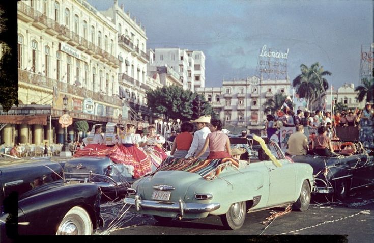 an old photo of people in cars on the street