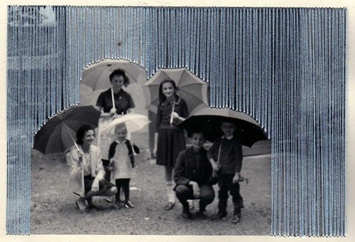 an old black and white photo of people with umbrellas