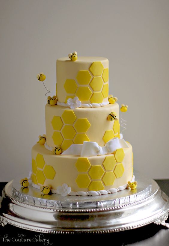 a three tiered cake with honeycombs on it