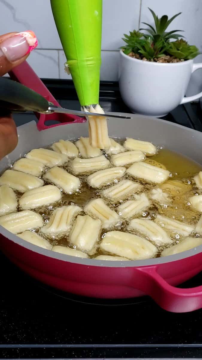 someone is using a green spatula to stir food in a pan on the stove