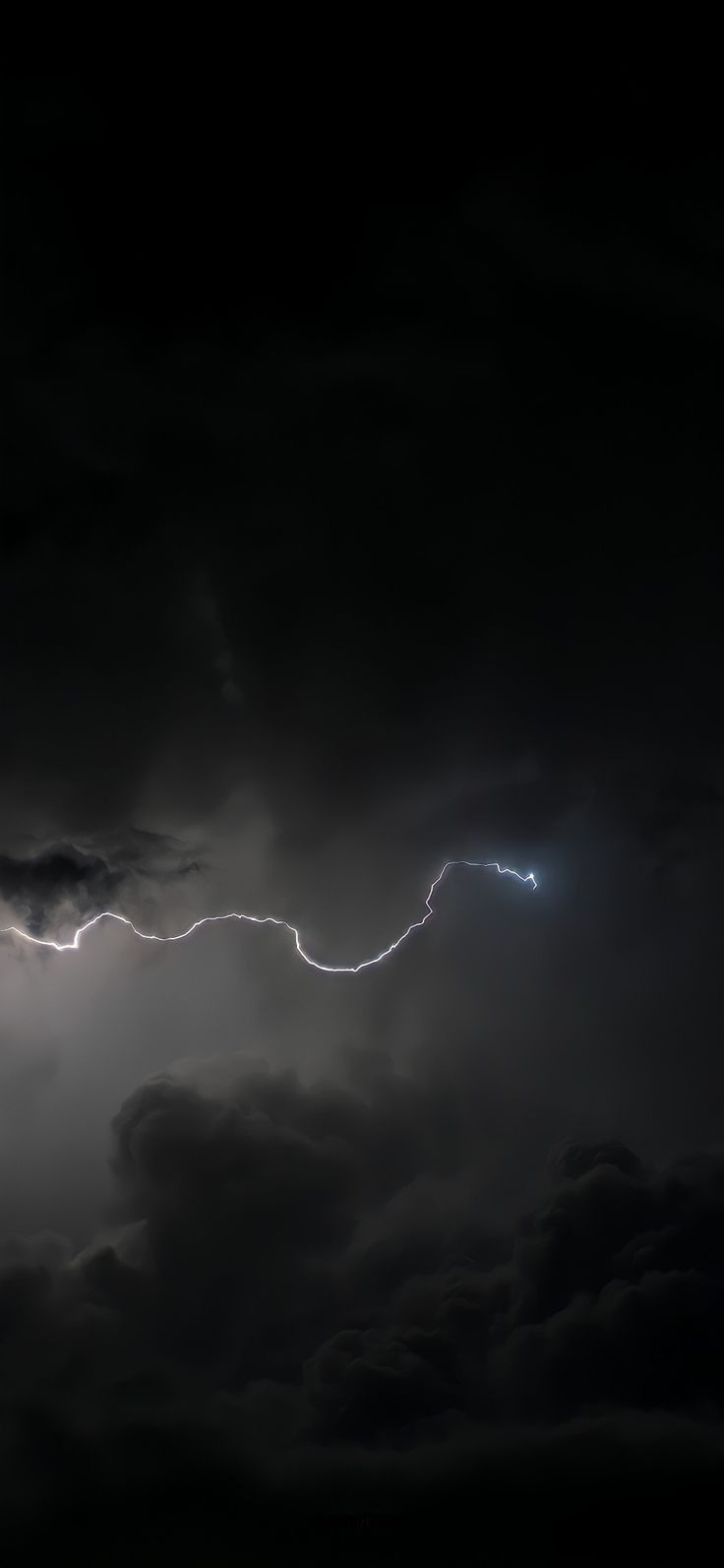 a lightning bolt hitting through the dark clouds