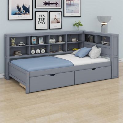 there is a bed with two storage drawers on the bottom and an open bookcase above it