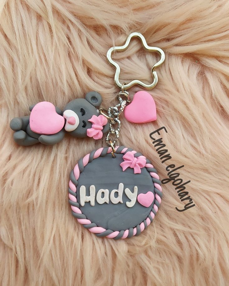 a teddy bear keychain that says,'happy'with two bears on it