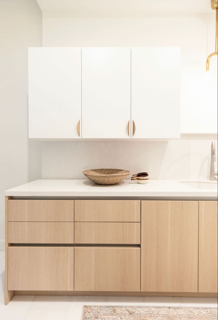 a bowl on top of a counter in a room with white walls and flooring