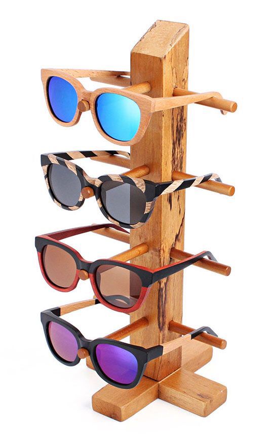 a wooden rack with several pairs of sunglasses on it