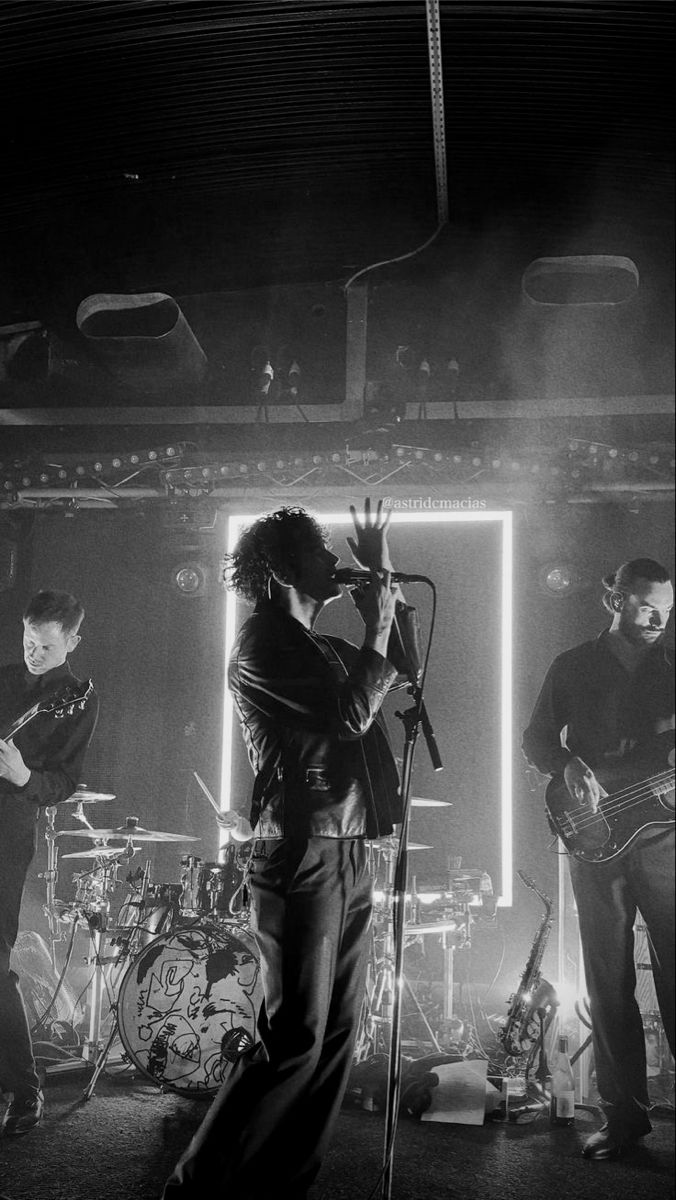 black and white photograph of band performing on stage