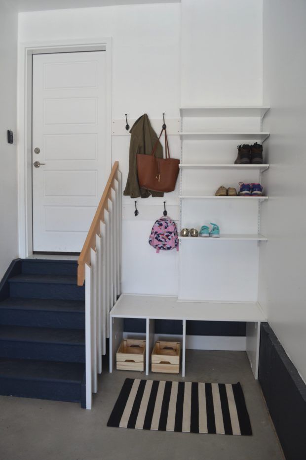 the entryway is clean and ready to be used as a shoe storage area for shoes