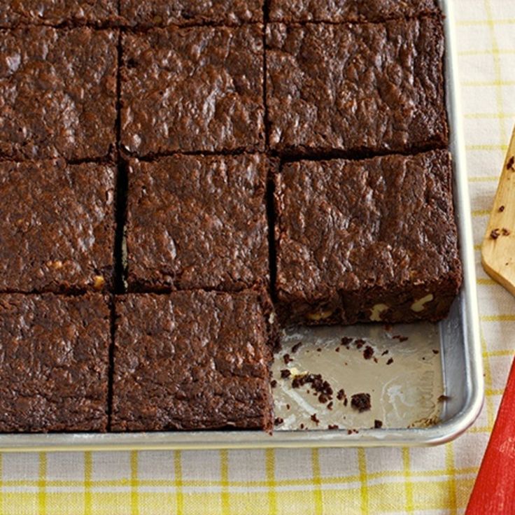 a pan filled with brownies sitting on top of a table