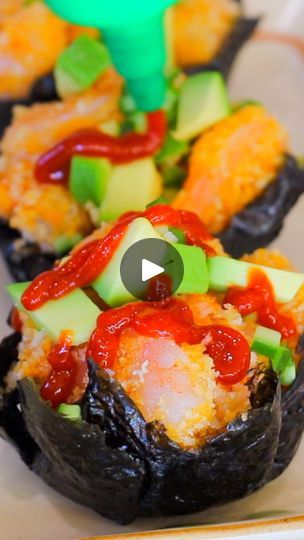 sushi rolls with sauce and cucumbers on them are ready to be eaten