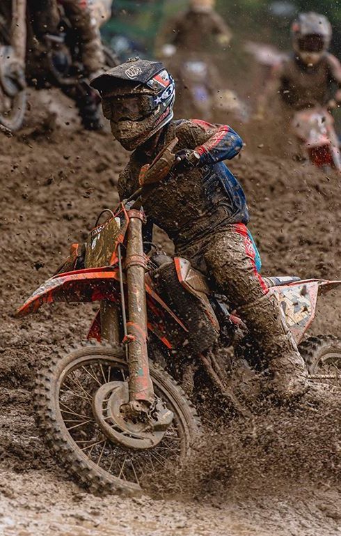 a man riding on the back of a dirt bike