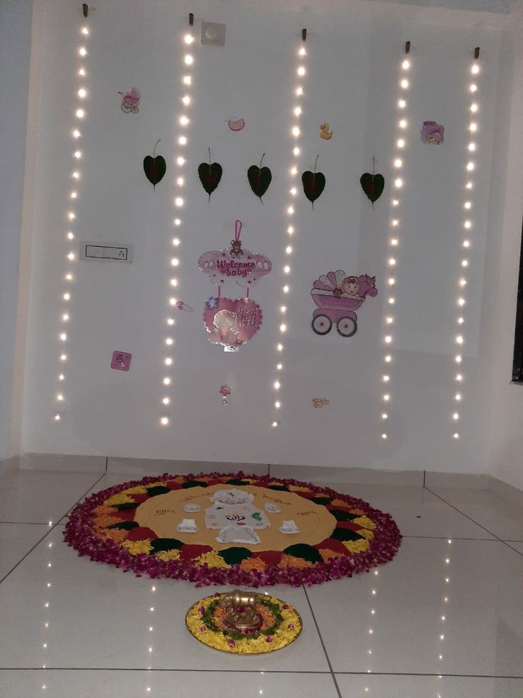 a white room with lights and decorations on the wall, including a baby's carriage