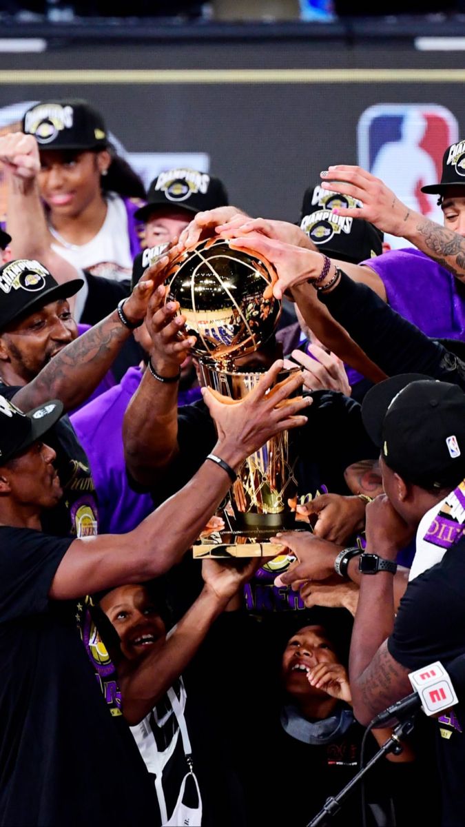 the lakers players are holding up their trophy