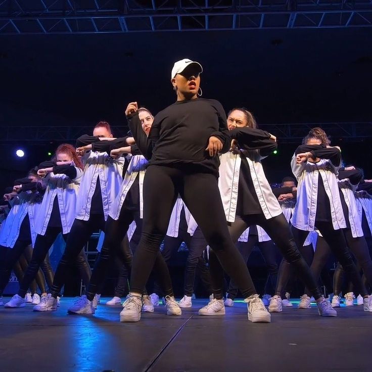 a group of people standing on top of a stage with one person in front of them